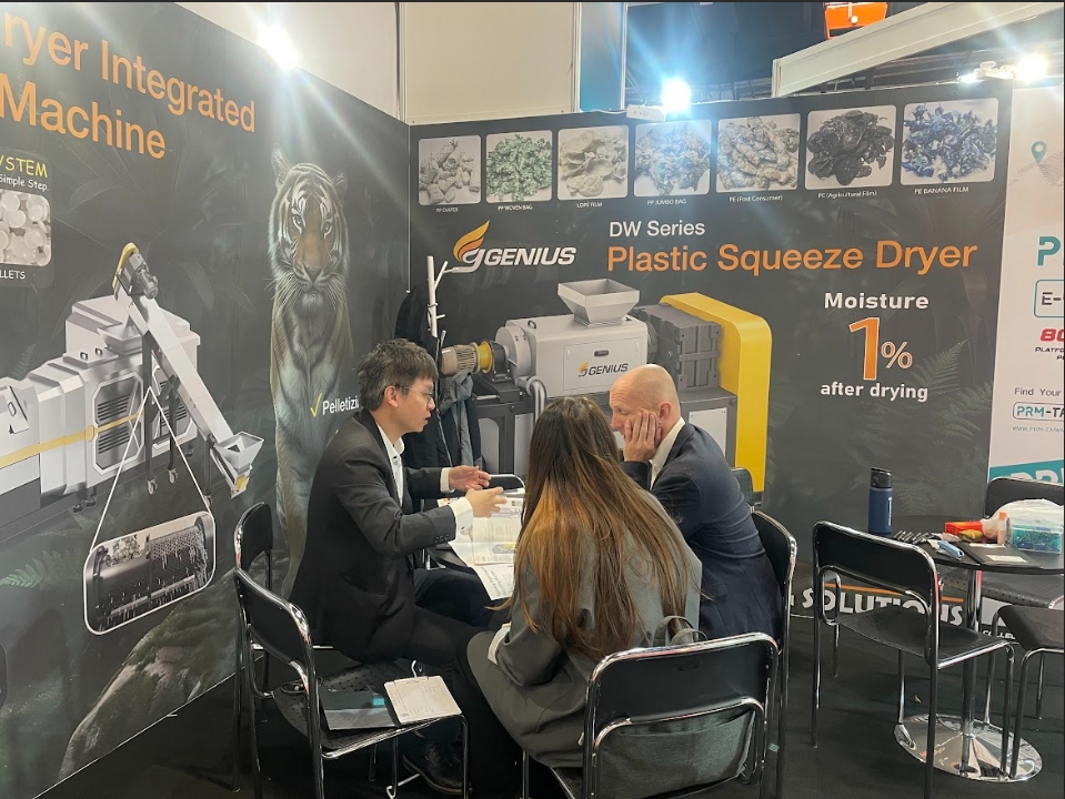 Genius at PLASPOL 2026 — discussing DW Series Plastic Squeeze Dryer specifications with recyclers processing post-consumer waste streams.